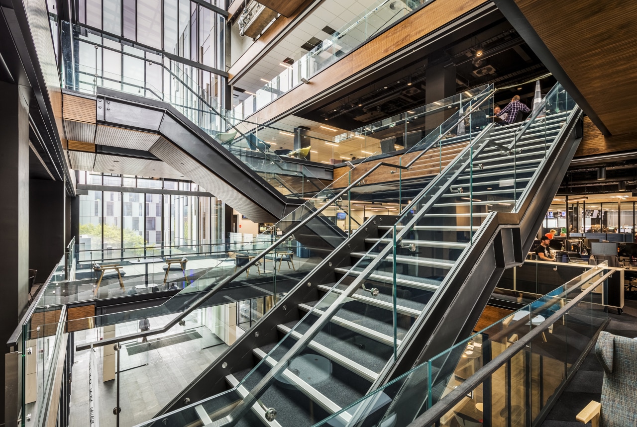 The central atrium of 2 Graham St by architecture, building, handrail, mixed use, stairs, black, white