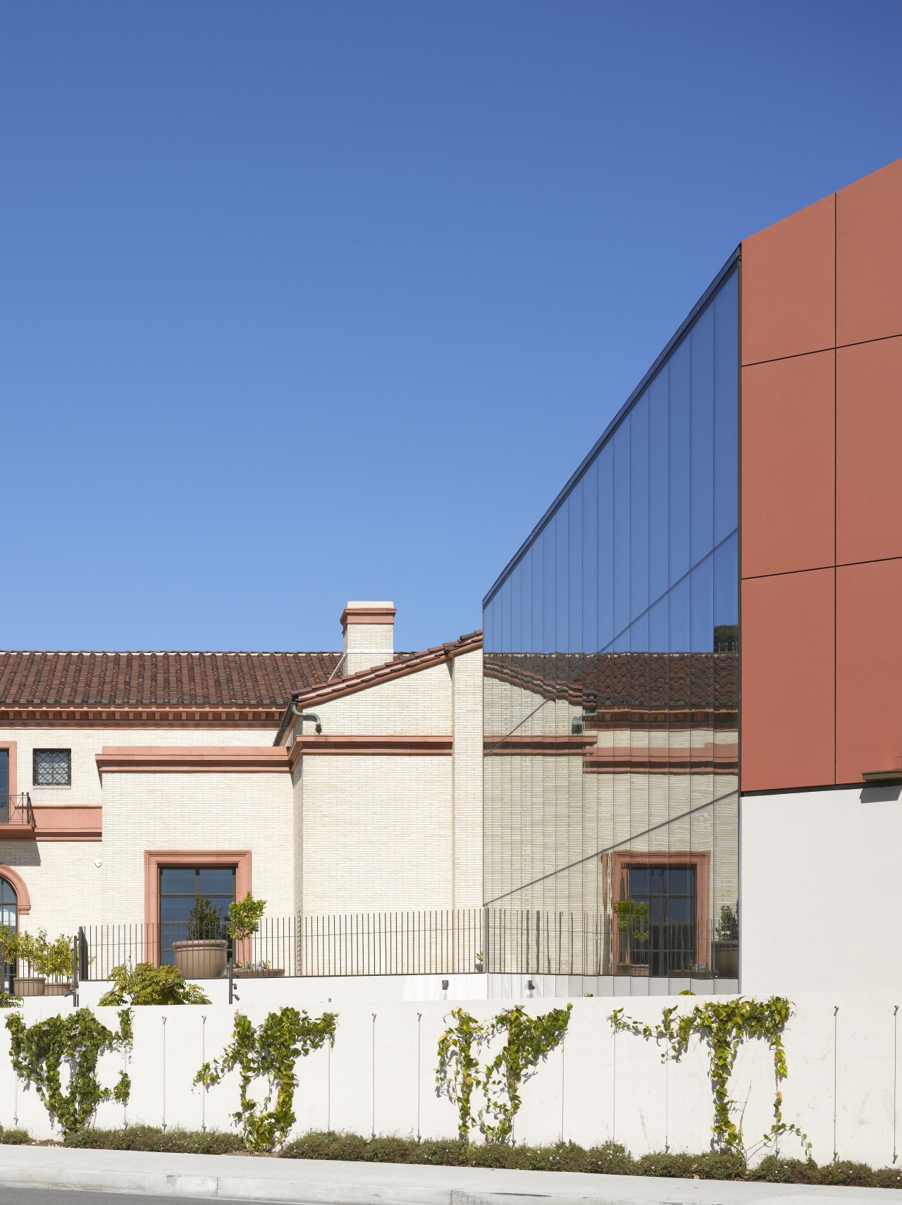 The new facade reflects the old in this architecture, building, commercial building, daytime, elevation, facade, home, house, line, neighbourhood, property, real estate, residential area, roof, sky, suburb, blue, white