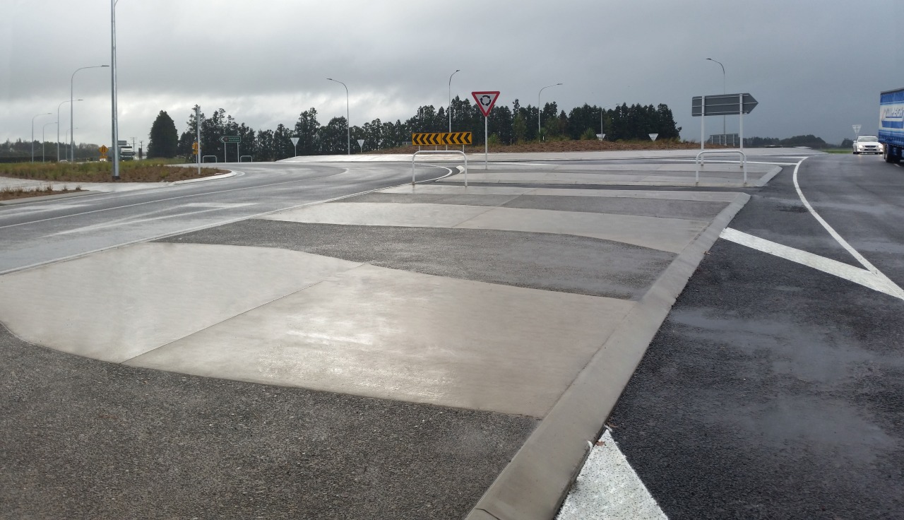 A traffic circle near Hamilton airport benefits from asphalt, lane, road, road surface, gray