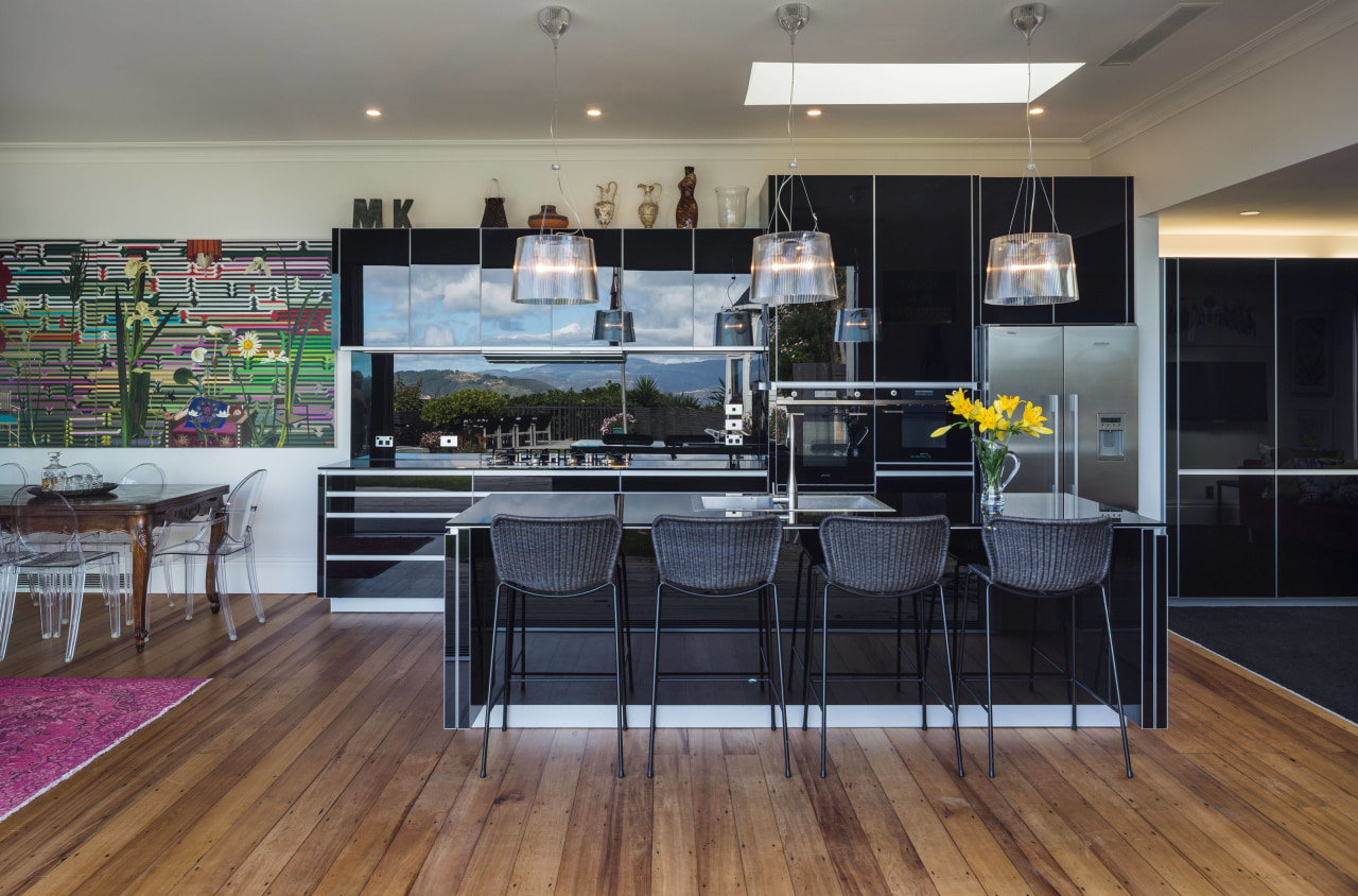 This kitchens black, reflective cabinetry runs on into floor, flooring, interior design, kitchen, real estate, gray, black