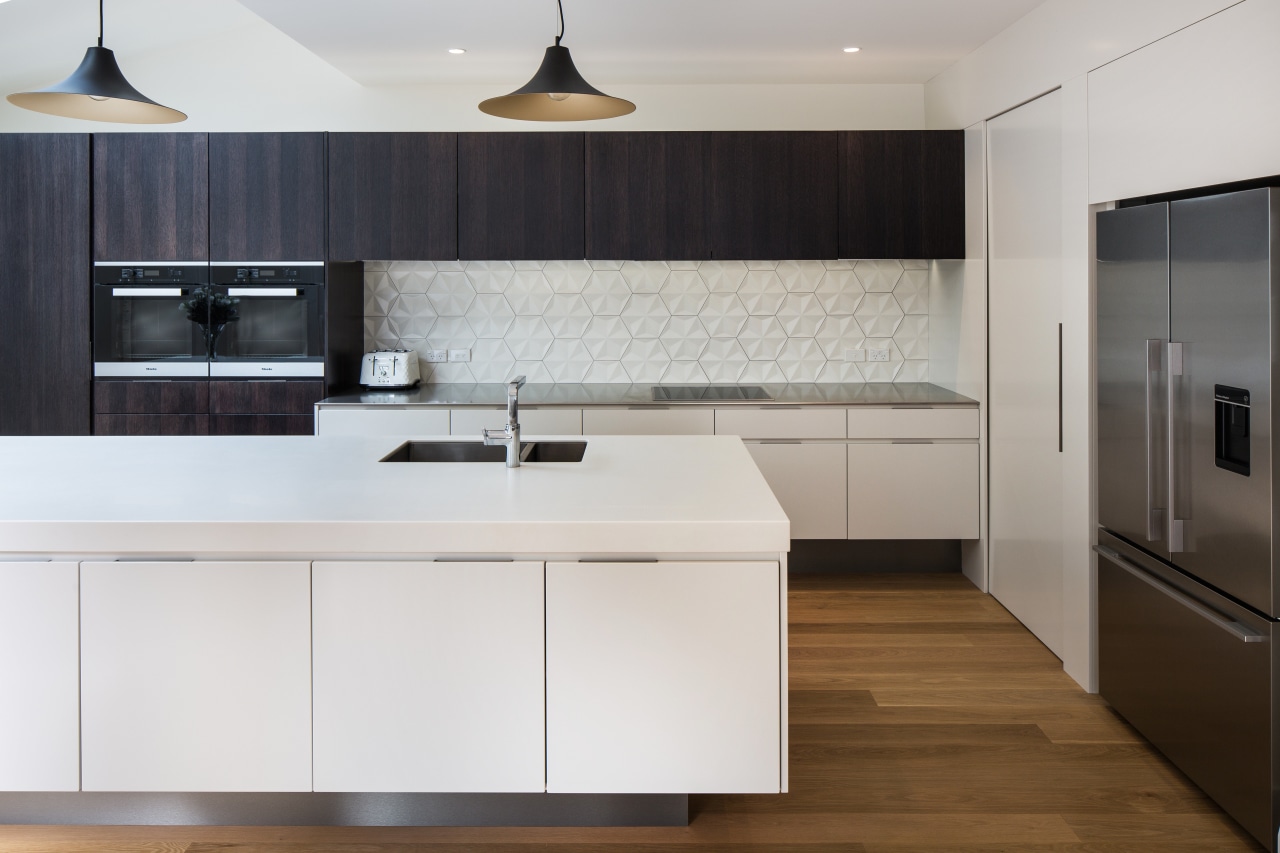 Contrasting the mainly crisp, clean surfaces, the splashback cabinetry, countertop, cuisine classique, floor, home appliance, interior design, kitchen, product design, room, wood flooring, gray