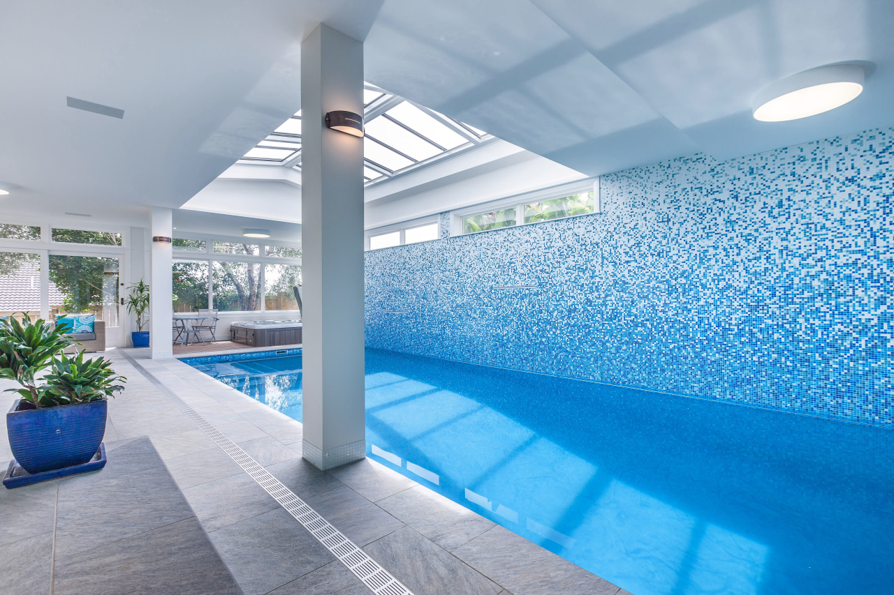 This spectacular pool and tiled mosaic wall were apartment, architecture, ceiling, daylighting, estate, interior design, leisure, leisure centre, property, real estate, swimming pool, gray, teal