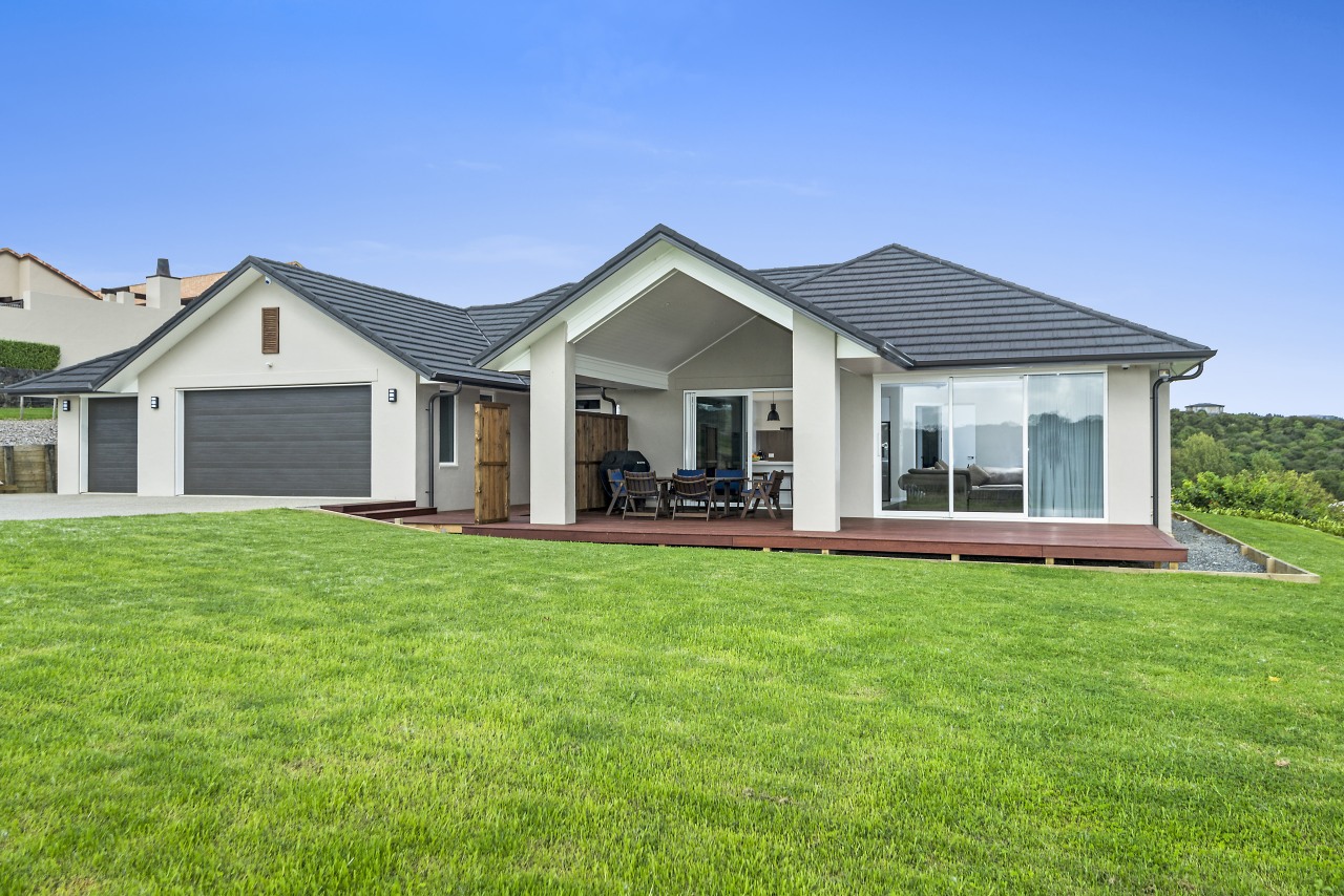 Twin peaks distinctive roof forms are all part cottage, elevation, estate, facade, farmhouse, grass, home, house, land lot, landscape, lawn, property, real estate, residential area, roof, siding, sky, villa, yard, green, teal