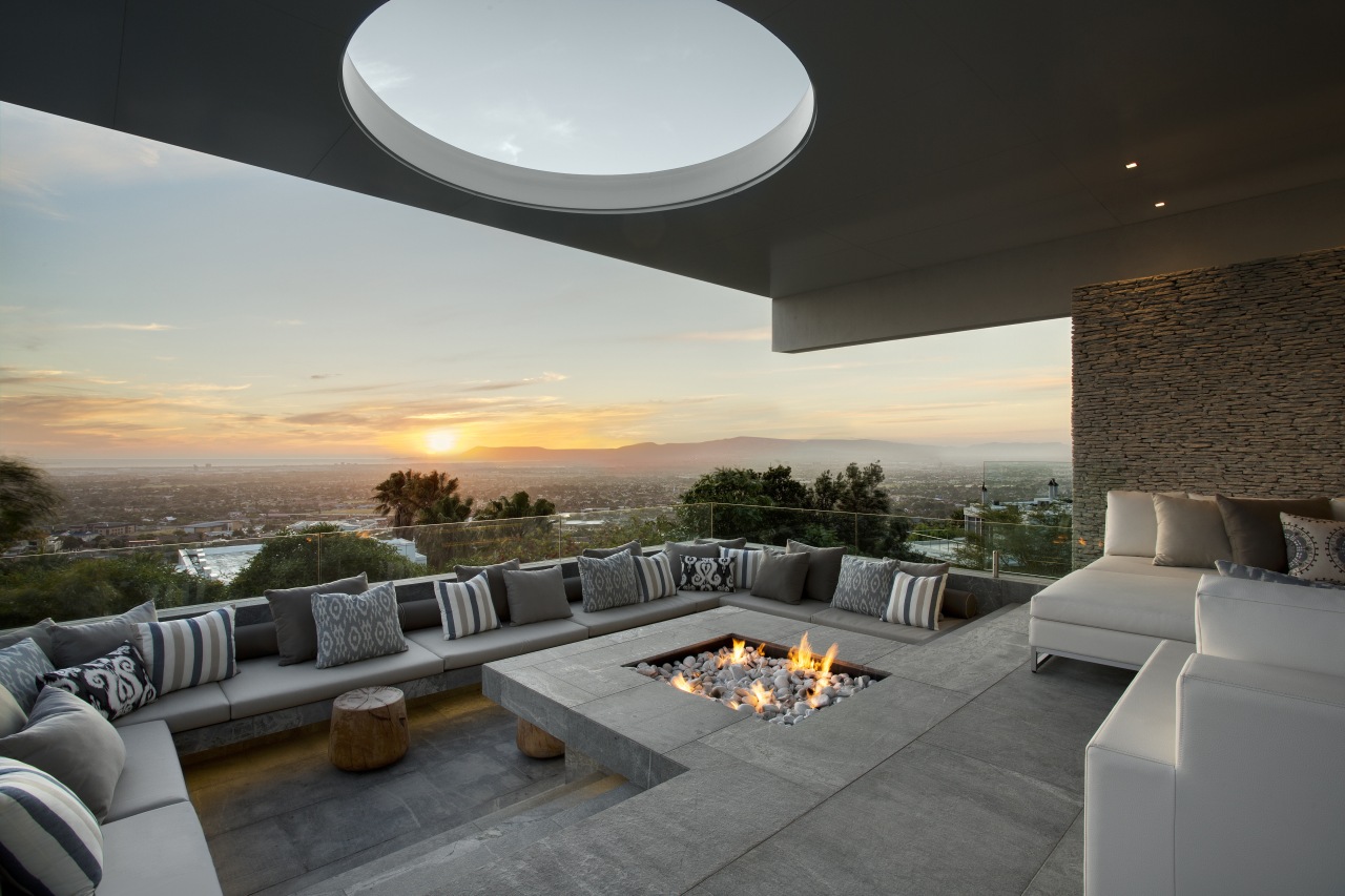 This sunken seating area, complete with firepit, allows apartment, architecture, estate, home, house, interior design, living room, property, real estate, sky, gray, black