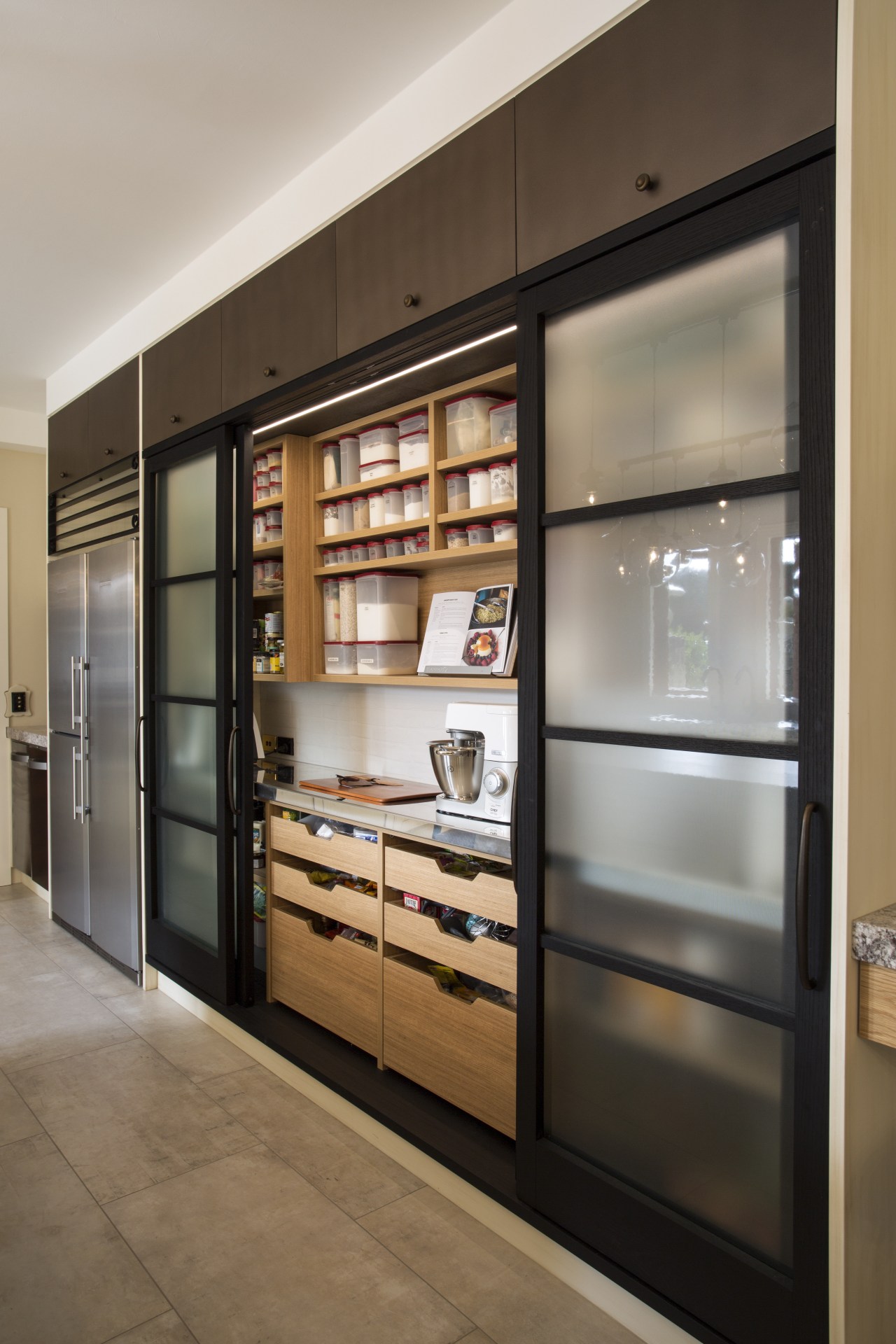 The pantry door frames and large flagstone-like floor cabinetry, display case, furniture, interior design, shelving, gray, brown, black