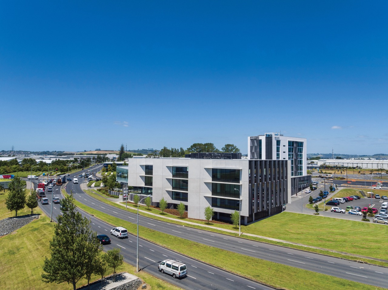 Building Five at the centrally located Highbrook Business bird's eye view, building, city, controlled access highway, corporate headquarters, daytime, highway, infrastructure, lane, metropolitan area, mixed use, real estate, residential area, road, sky, suburb, tower block, urban area, blue