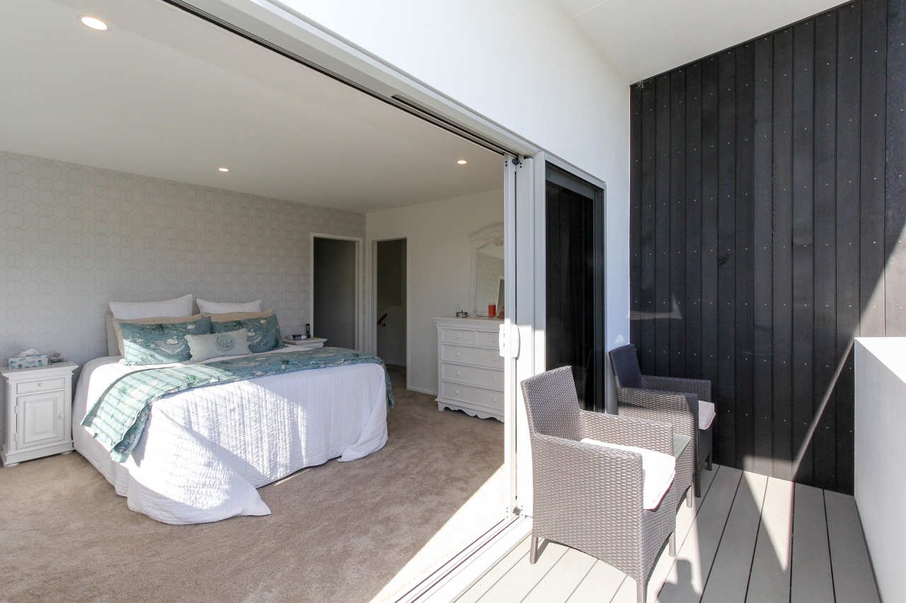 Stacker doors provide a seamless indoor-outdoor connection in bedroom, ceiling, floor, home, interior design, property, real estate, room, suite, wall, gray