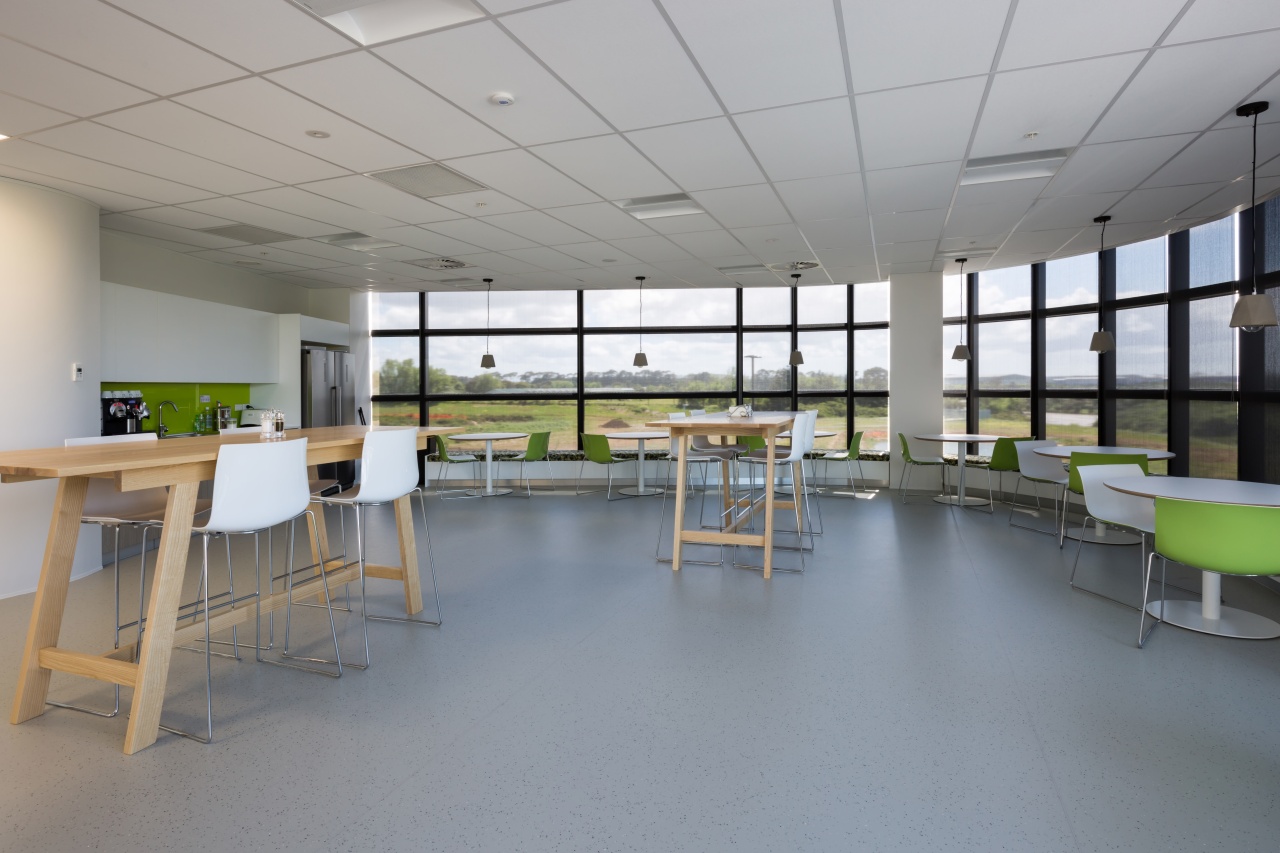 Armstrong Ultima ceiling tilesideally complement the Sistema building architecture, cafeteria, classroom, daylighting, institution, interior design, table, gray