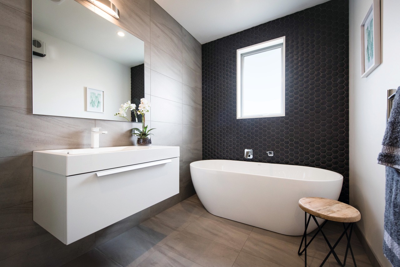 This contemporary GJ Gardner-designed bathroom includes a hexagon bathroom, floor, home, interior design, product design, room, sink, gray, black