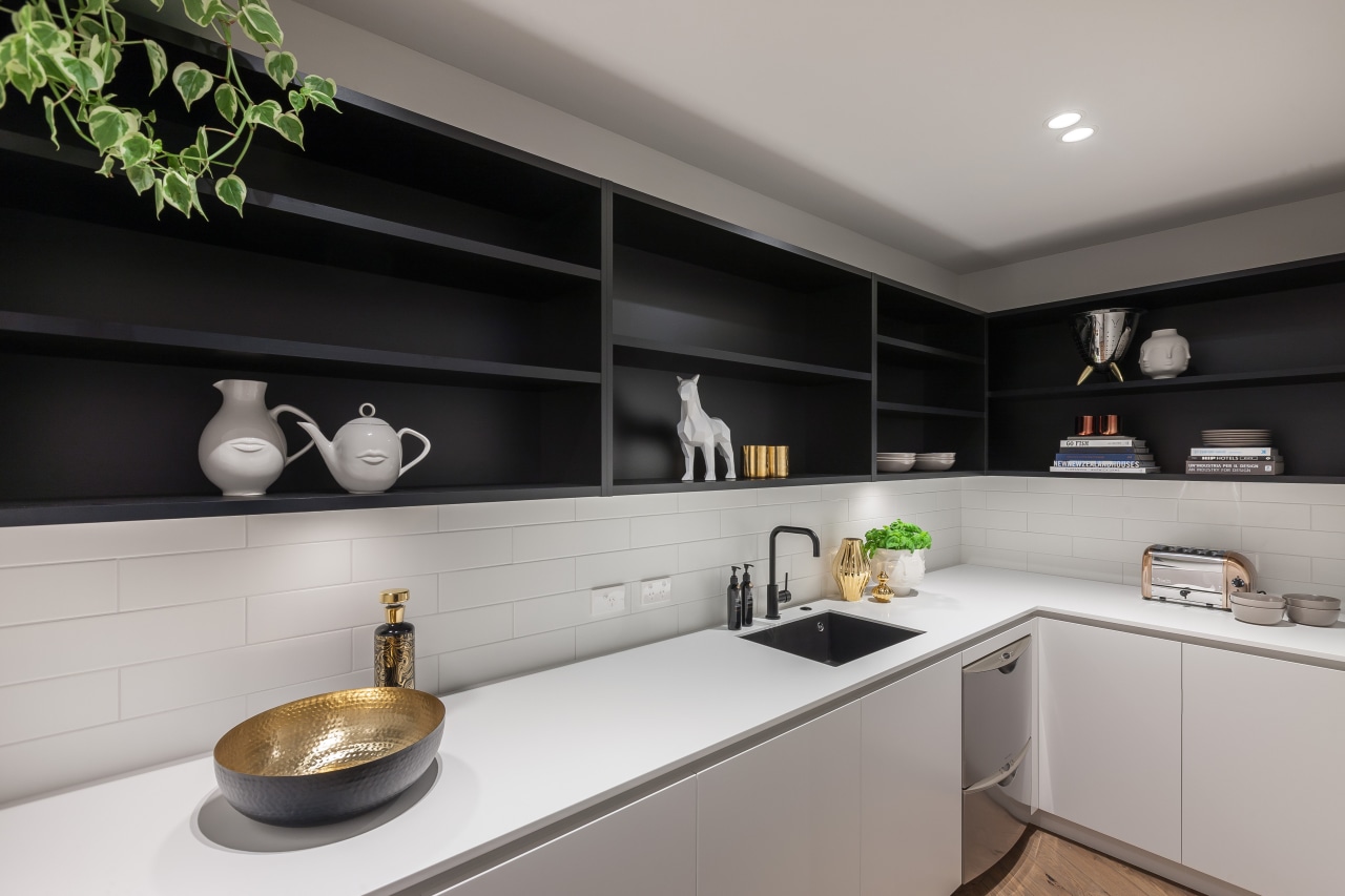 This walk-in scullery continues the look of the countertop, interior design, kitchen, gray, black