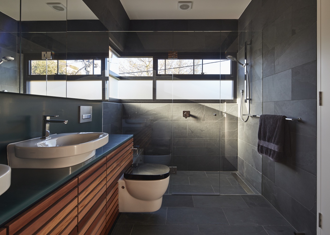 Slate tile flooring and matching wall tiles combine architecture, bathroom, room, black