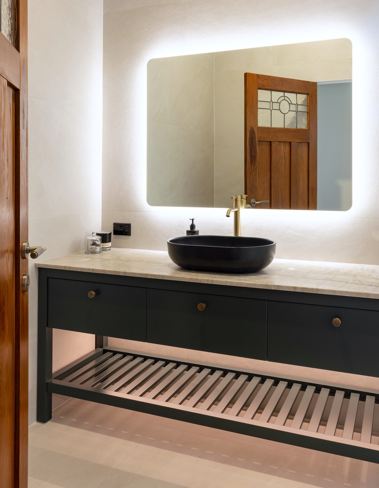 A backlit mirror contributes to the design impact. 