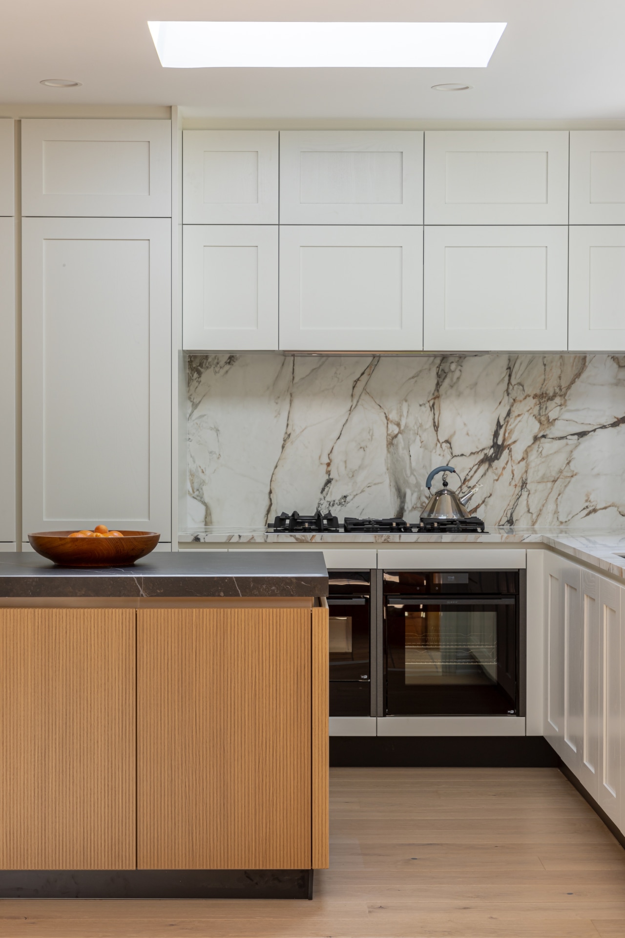 A skylight adds to the panelled kitchen's light 
