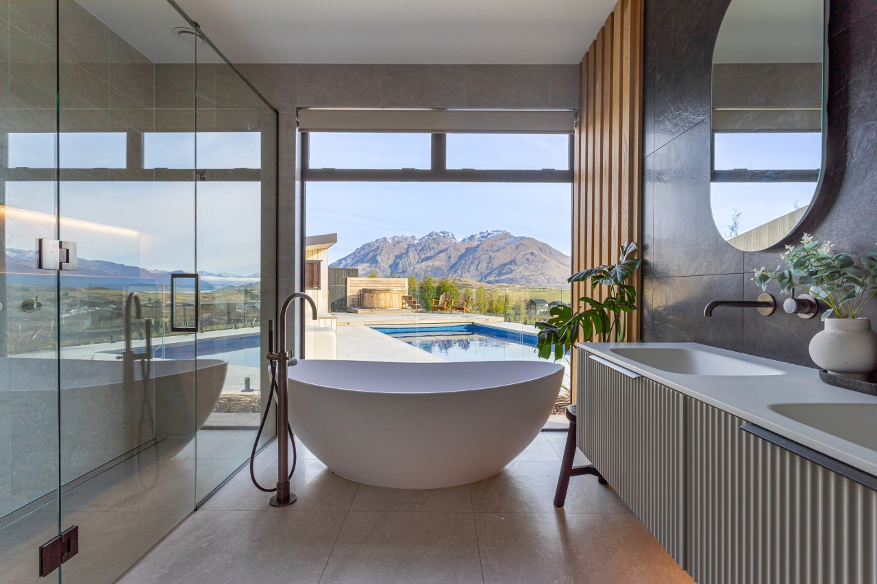 Main bathroom with sculptural tub and textured double 