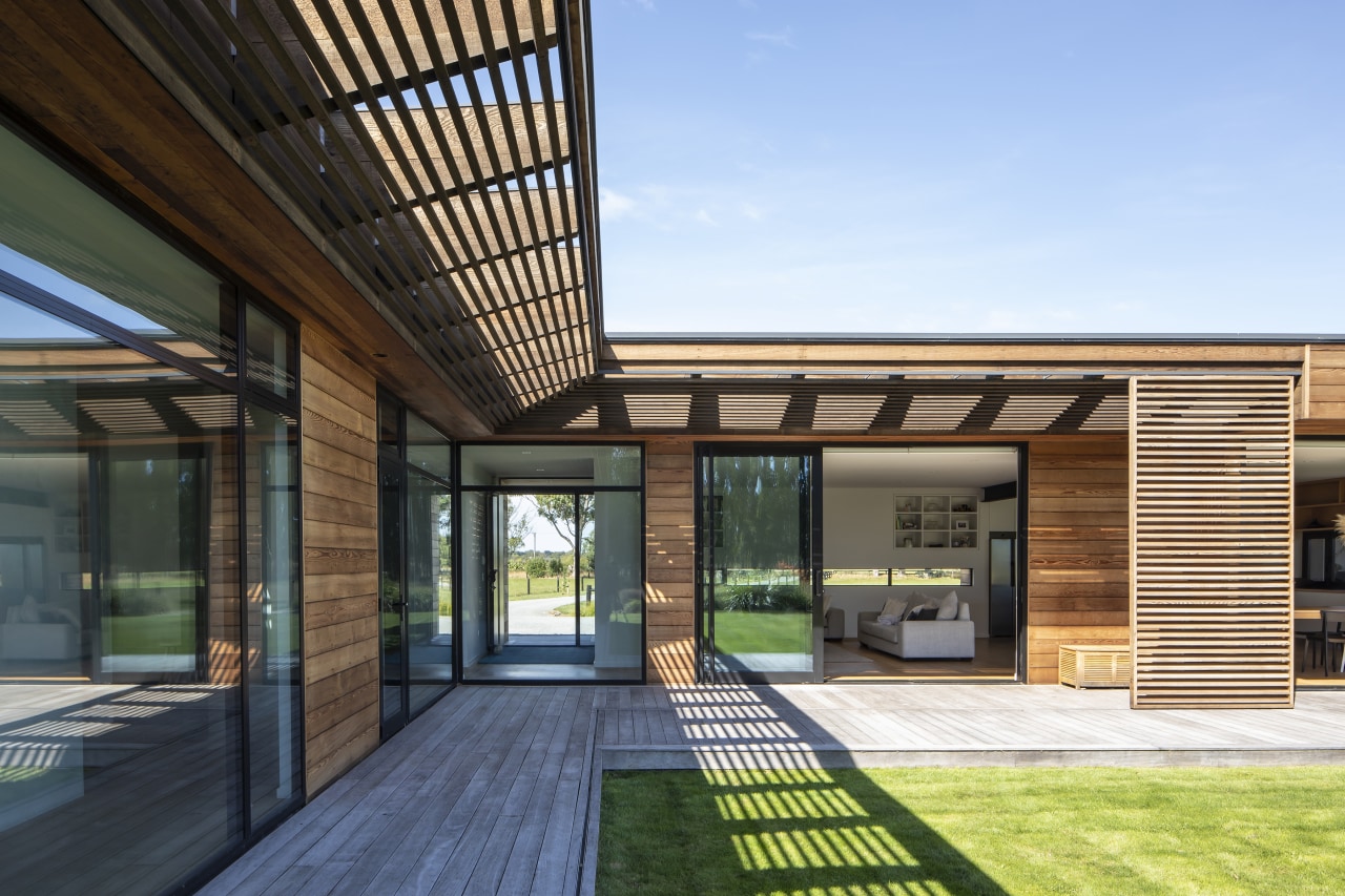 With a covered cedar clad walkway connecting the 