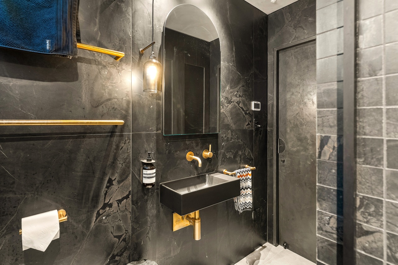 Brass fixtures stand out against the predominantly dark 