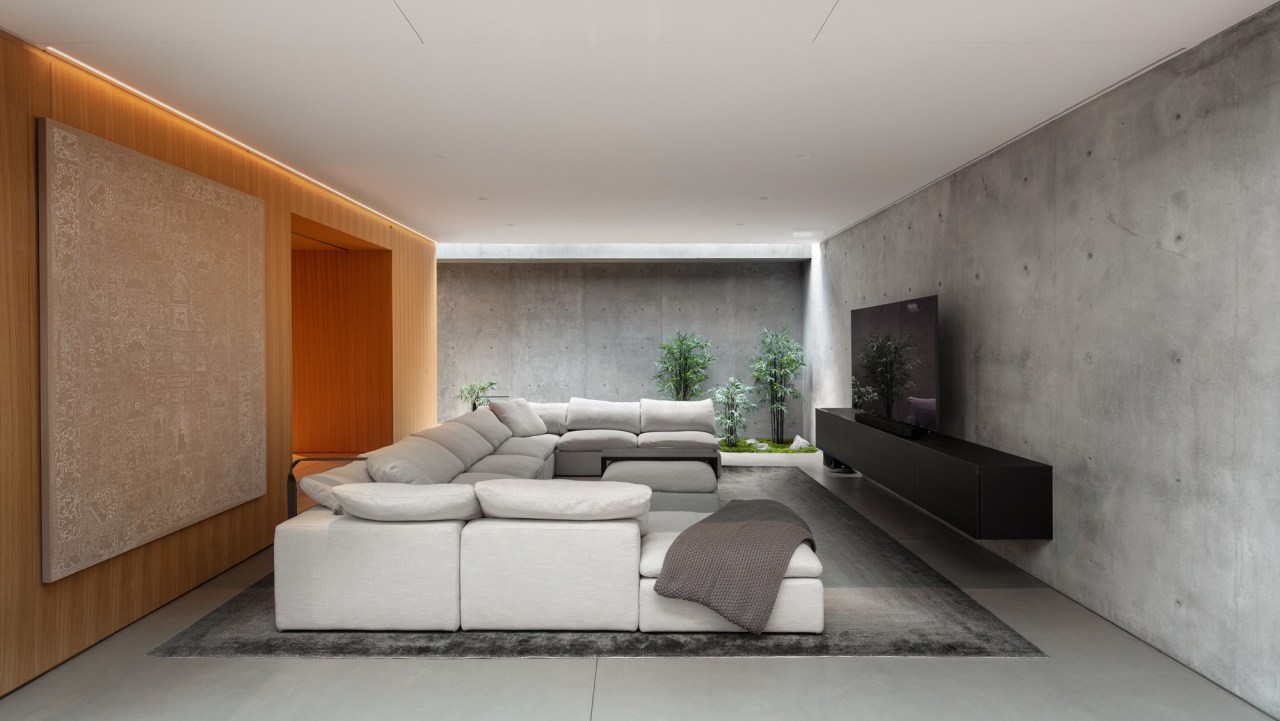 The dramatic media room features walls of concrete 