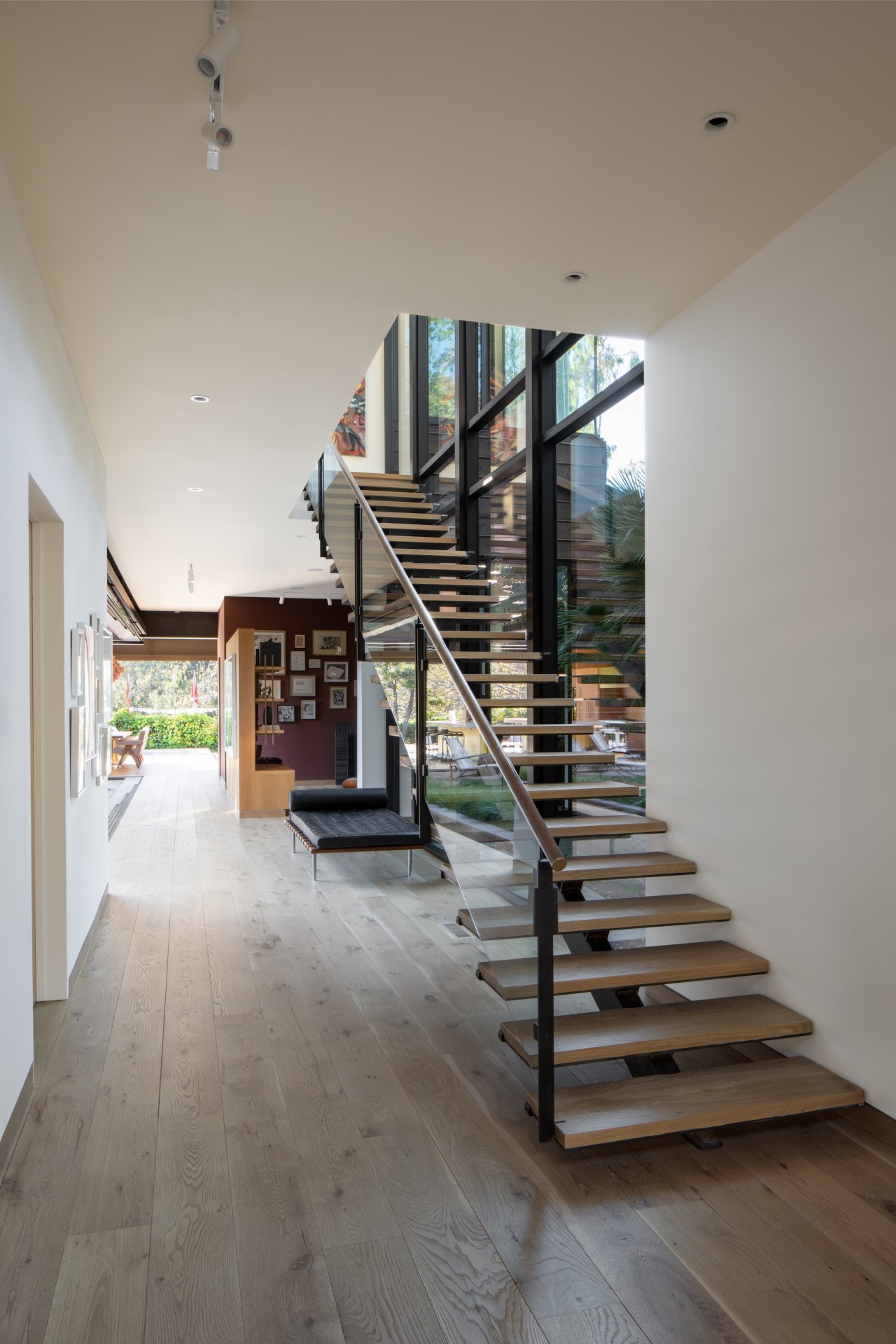 In the home’s generous entryway, glass and steel 