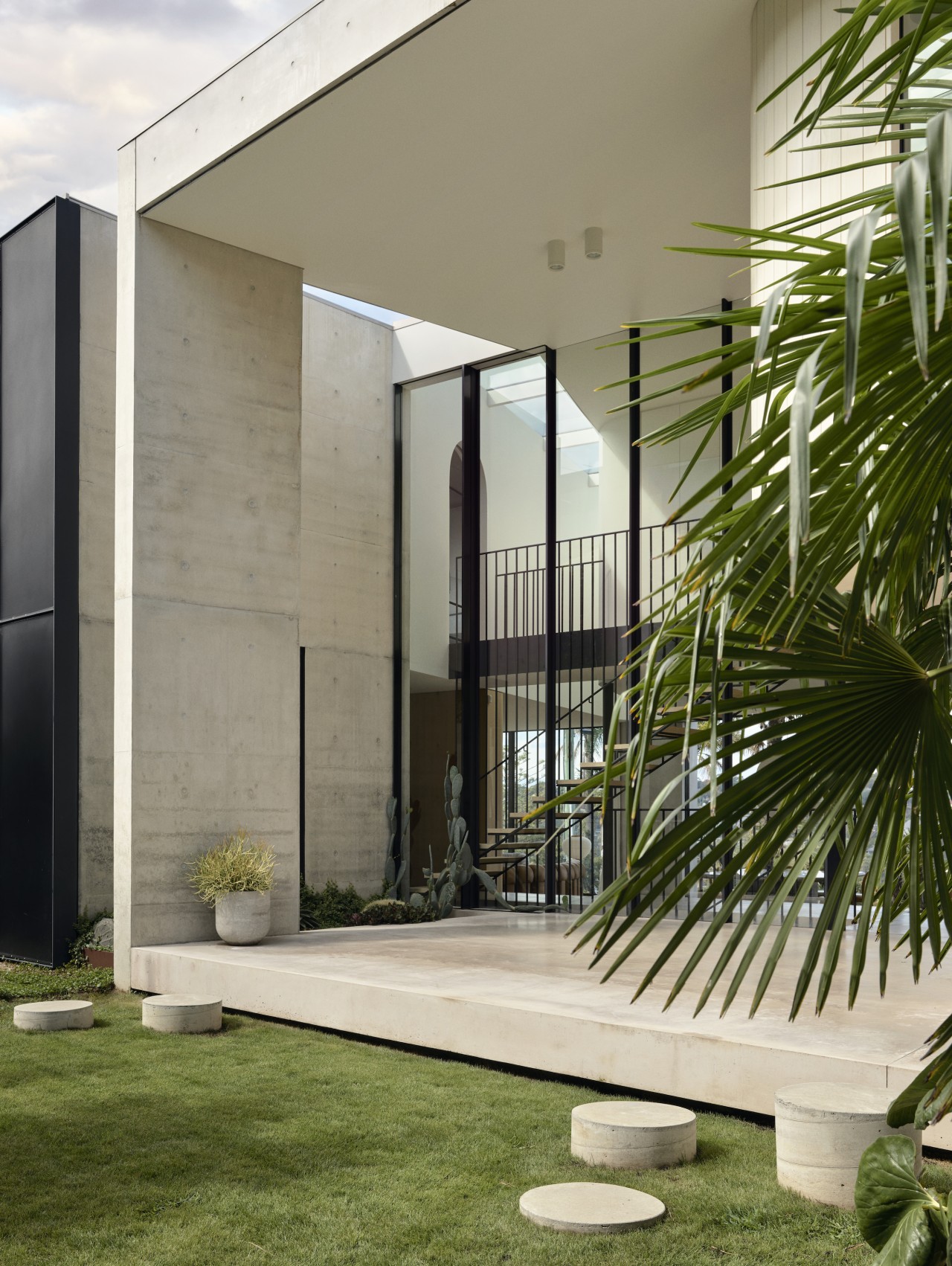 Back lawn with sculptural stepping stones. - Oasis 