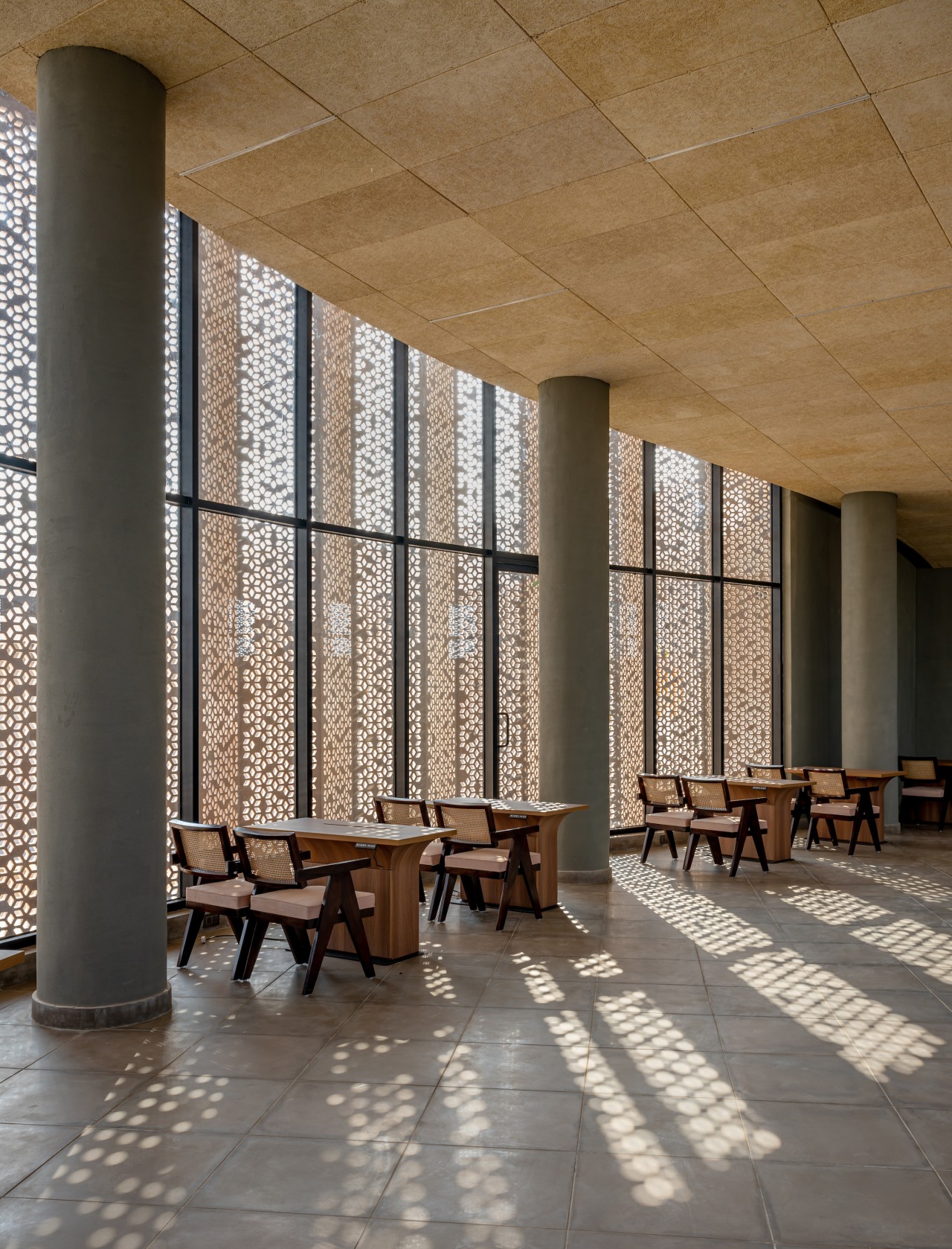 The facade screens create shadow play on the 