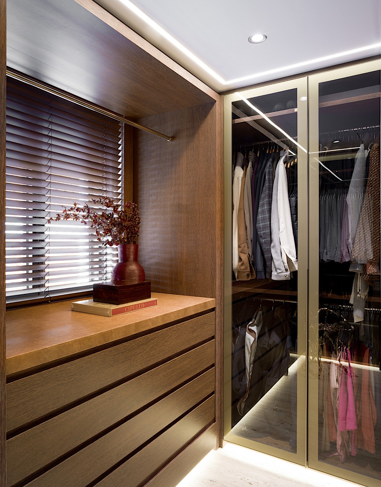 The walk-in wardrobe has high-end custom millwork, designed 