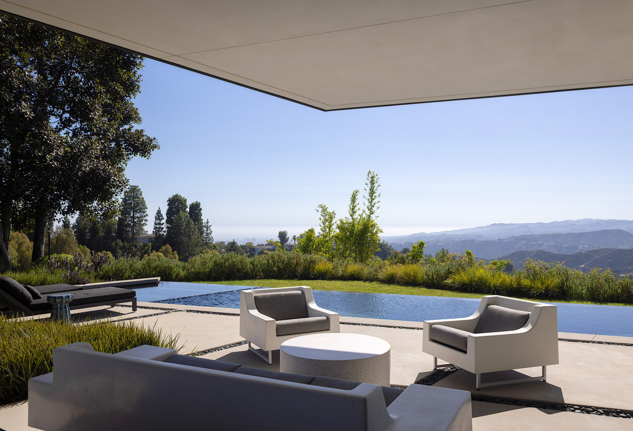 An infinity edge pool connects the home to 