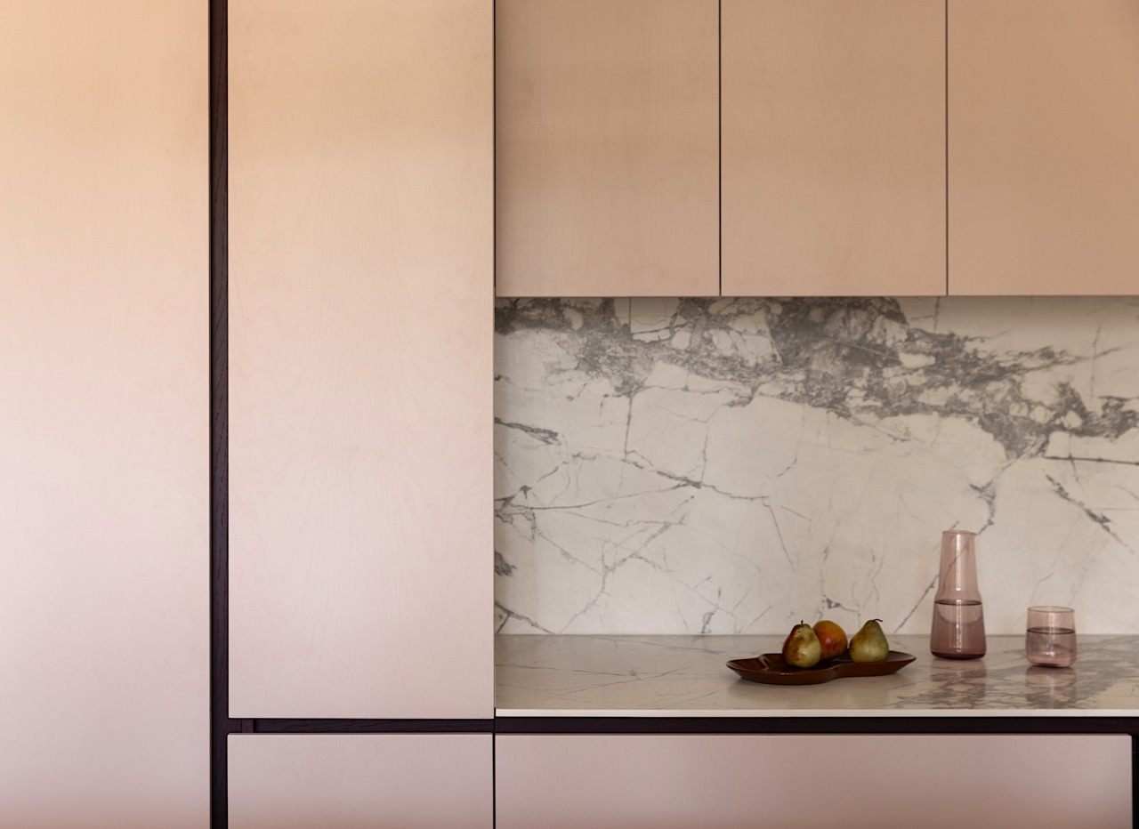 Custom joinery incorporates integrated handles and shadowlines for 