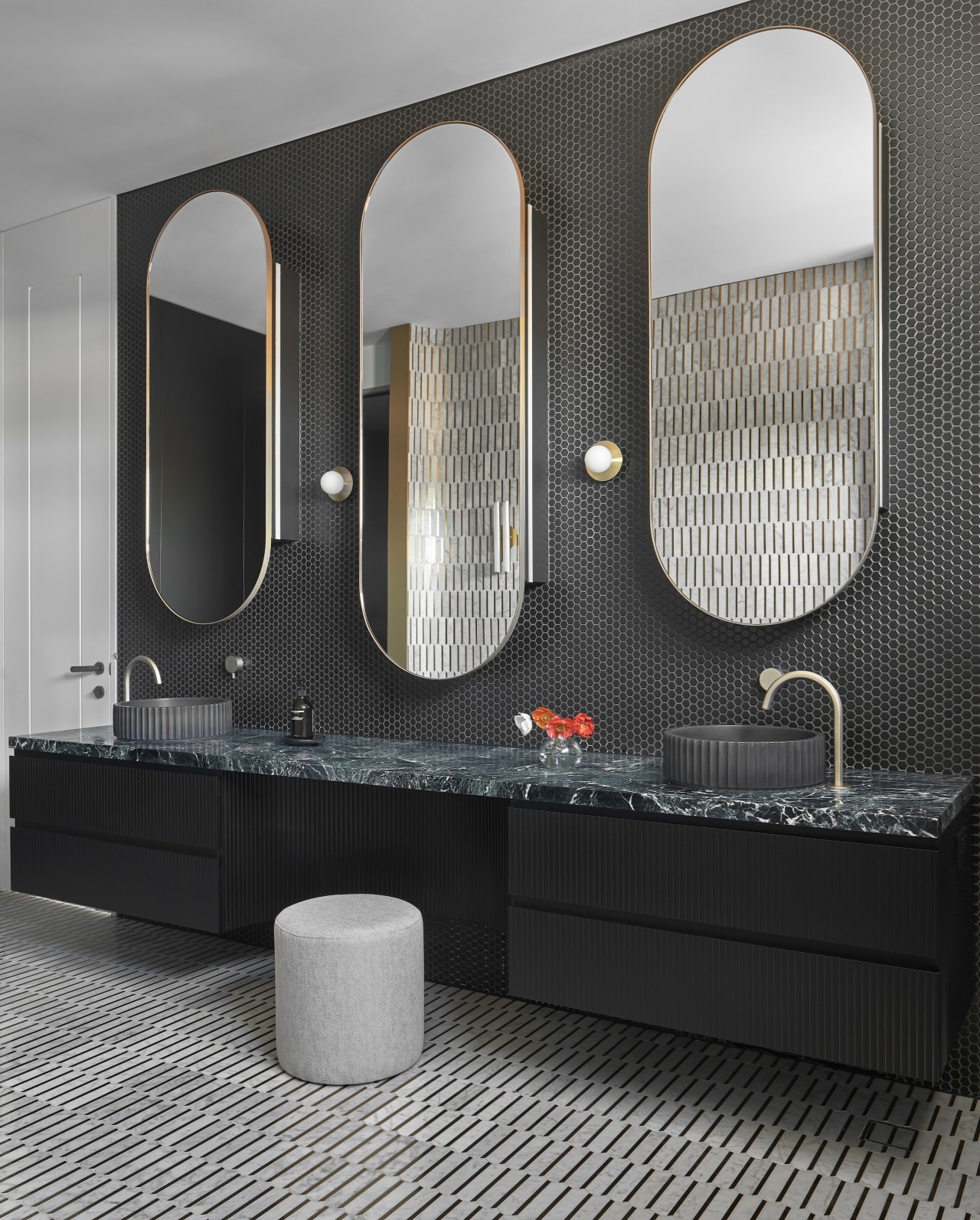 Floating vanity with three large mirrors fronting slender 