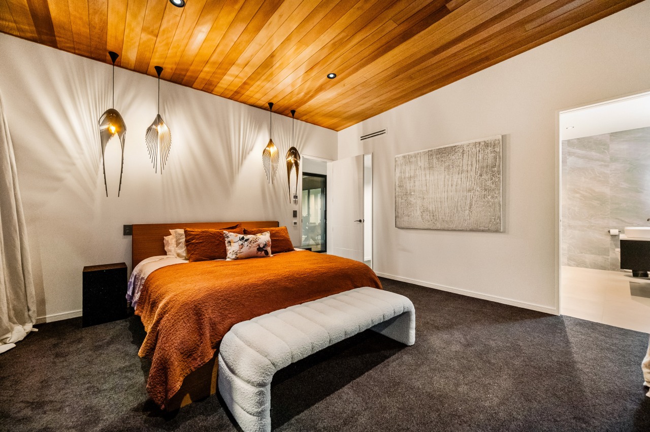 A raking cedar-lined ceiling and sculptural pendants feature 