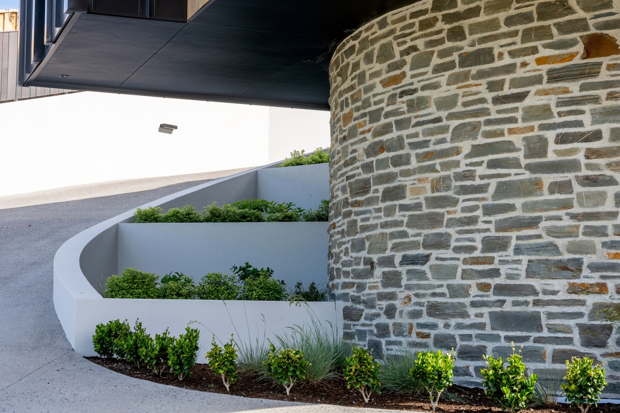 The schist wall greets visitors as they arrive. 