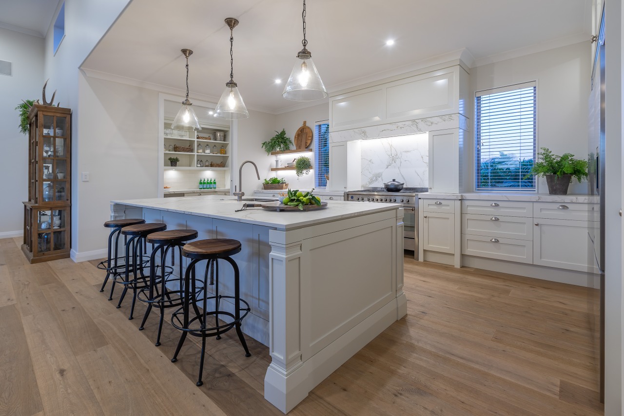 Beautiful pendants grace the island while bench seats