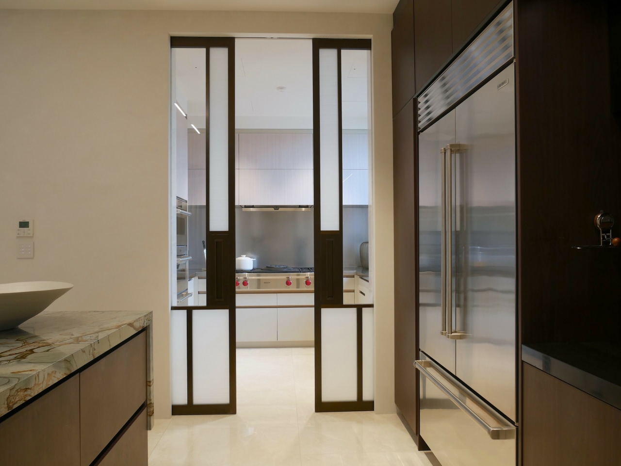 The scullery features oversized patterned glass doors set 