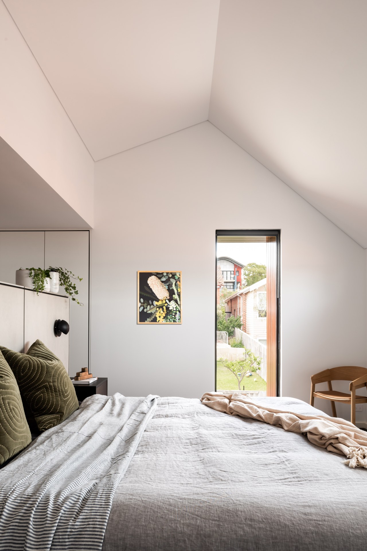 The master suite's steep gabled roofline translates into 