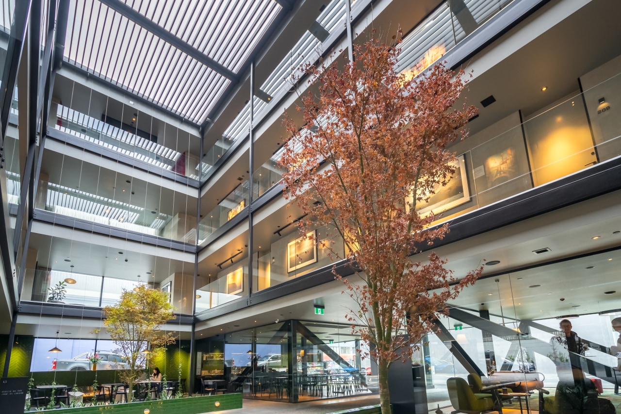 Semi-transparent glazed façades to hotel suites and walkway