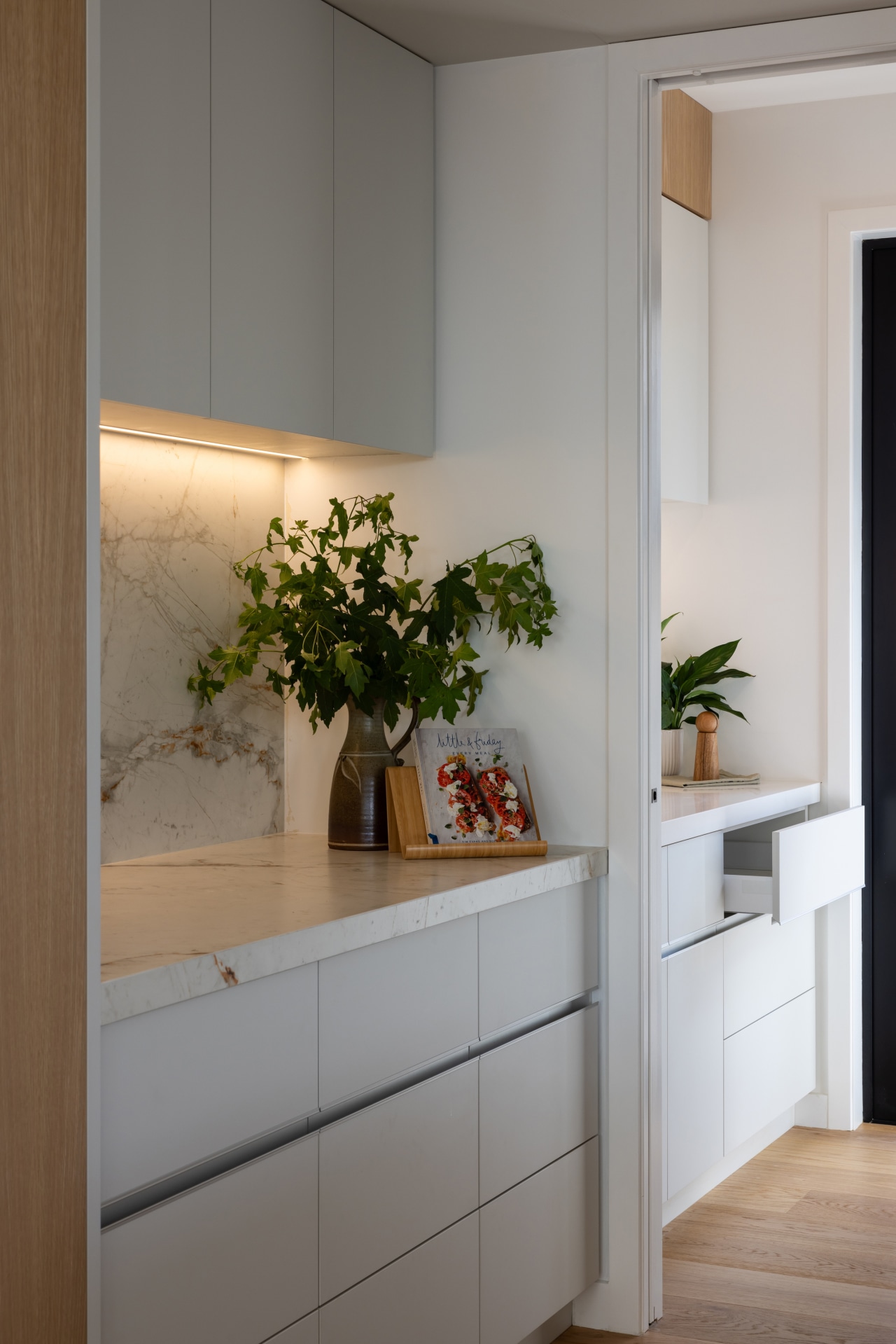 Side bench and cabinetry opening to the scullery 