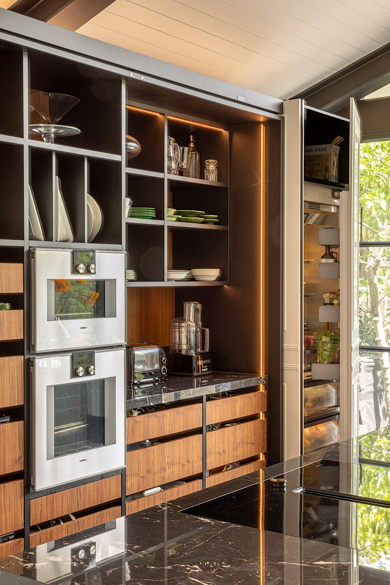 A wall of open shelving and drawers achieves 