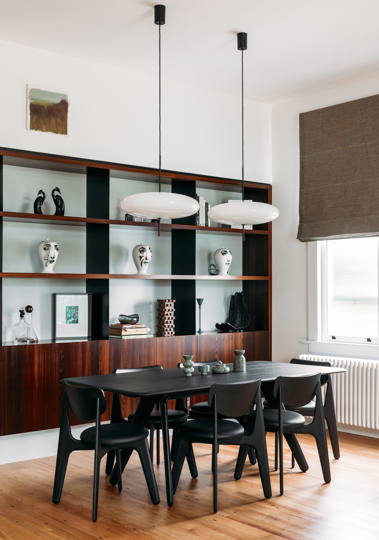 Dining area with display cabinetry behind, in the 