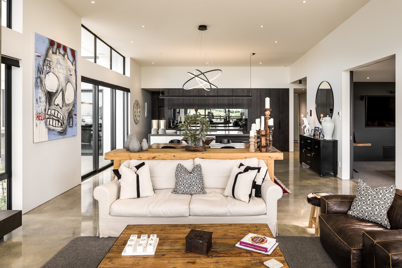 The double-height living area features, a raking ceiling 