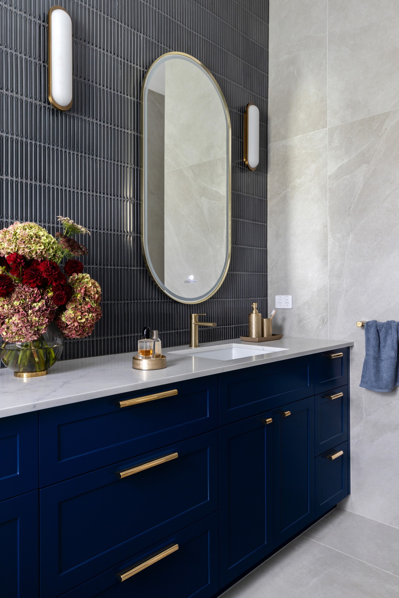 A stone benchtop contrasts the darker cabinetry and 