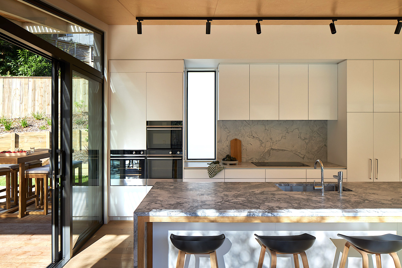 Kitchen island's stone benchtop in the sunlight. 