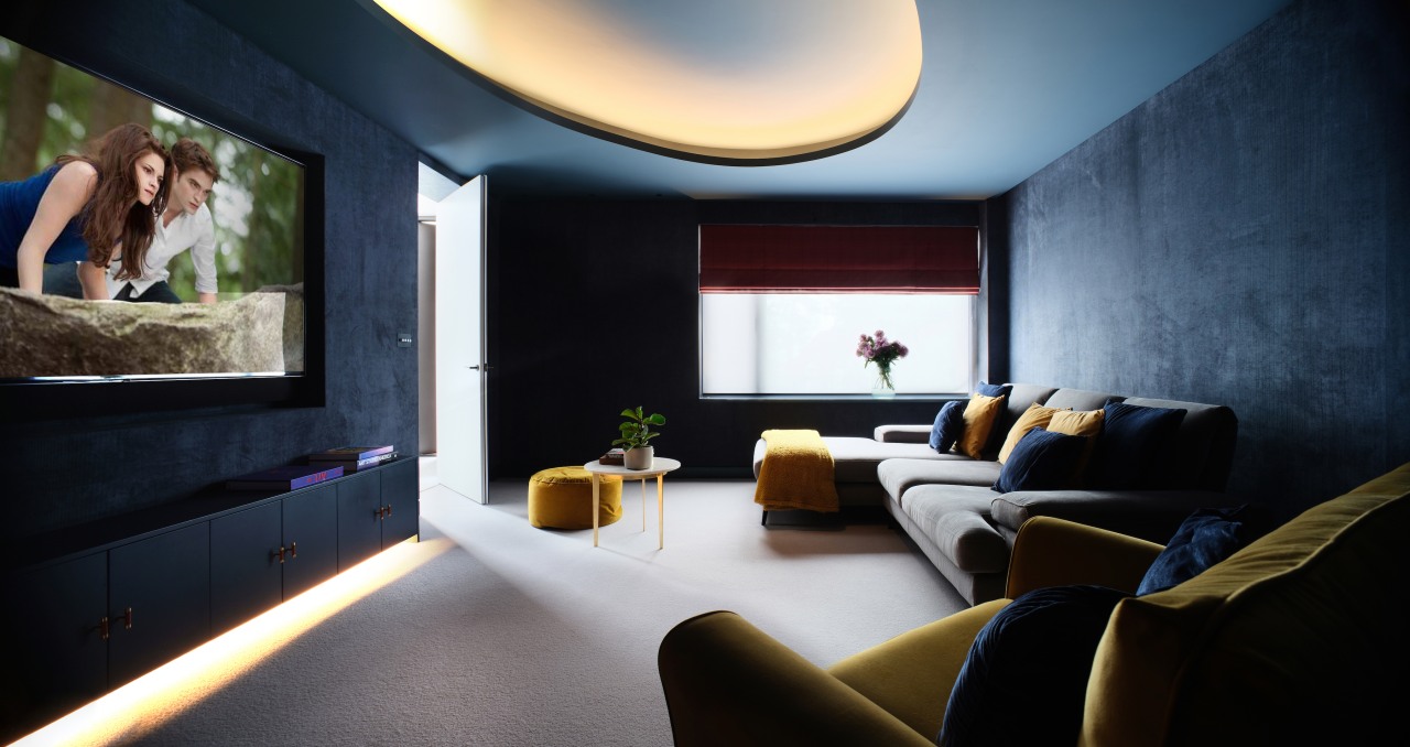 Indirect lighting and dark wall tones set the 