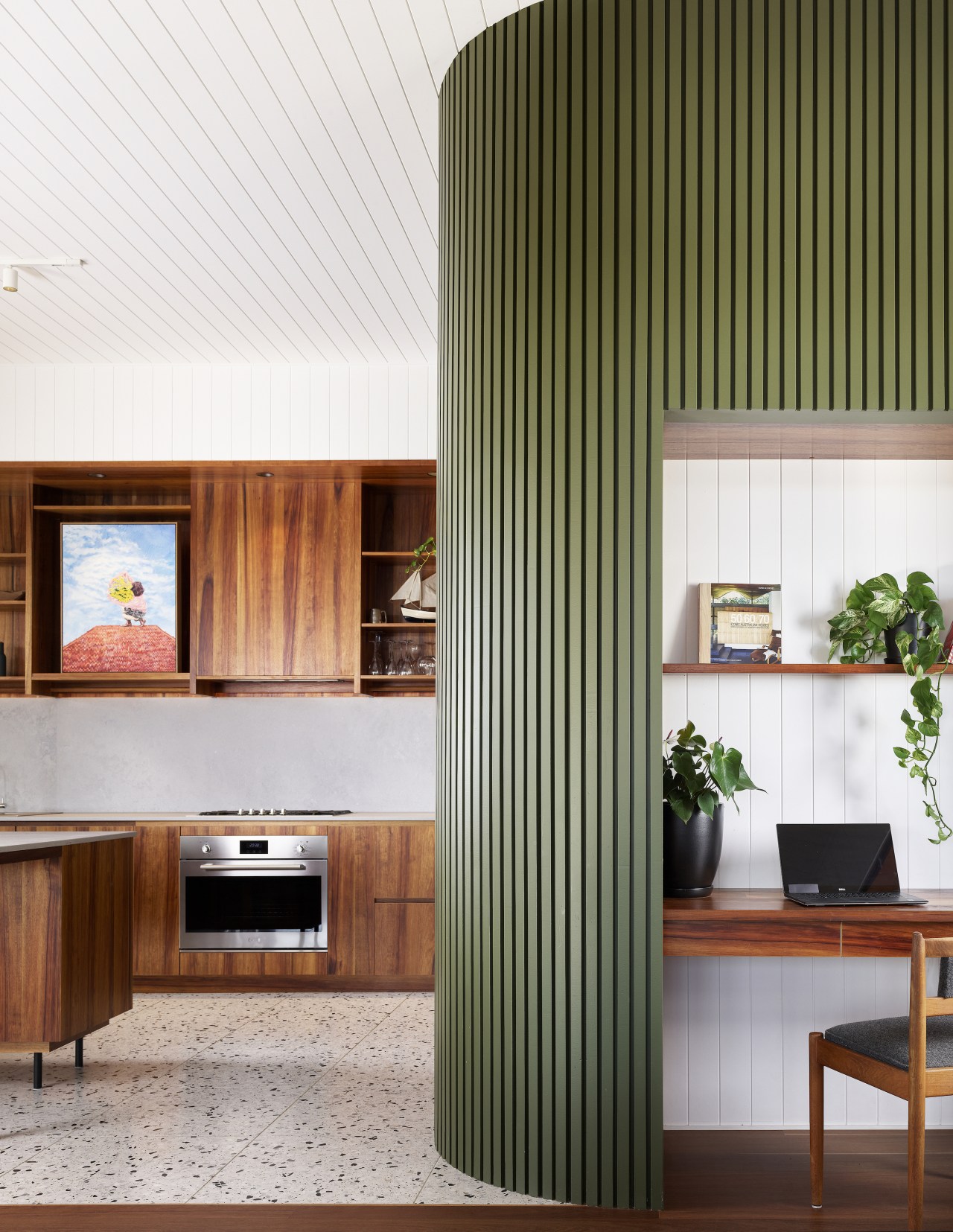 The batten cabinetry wall also encloses a home 