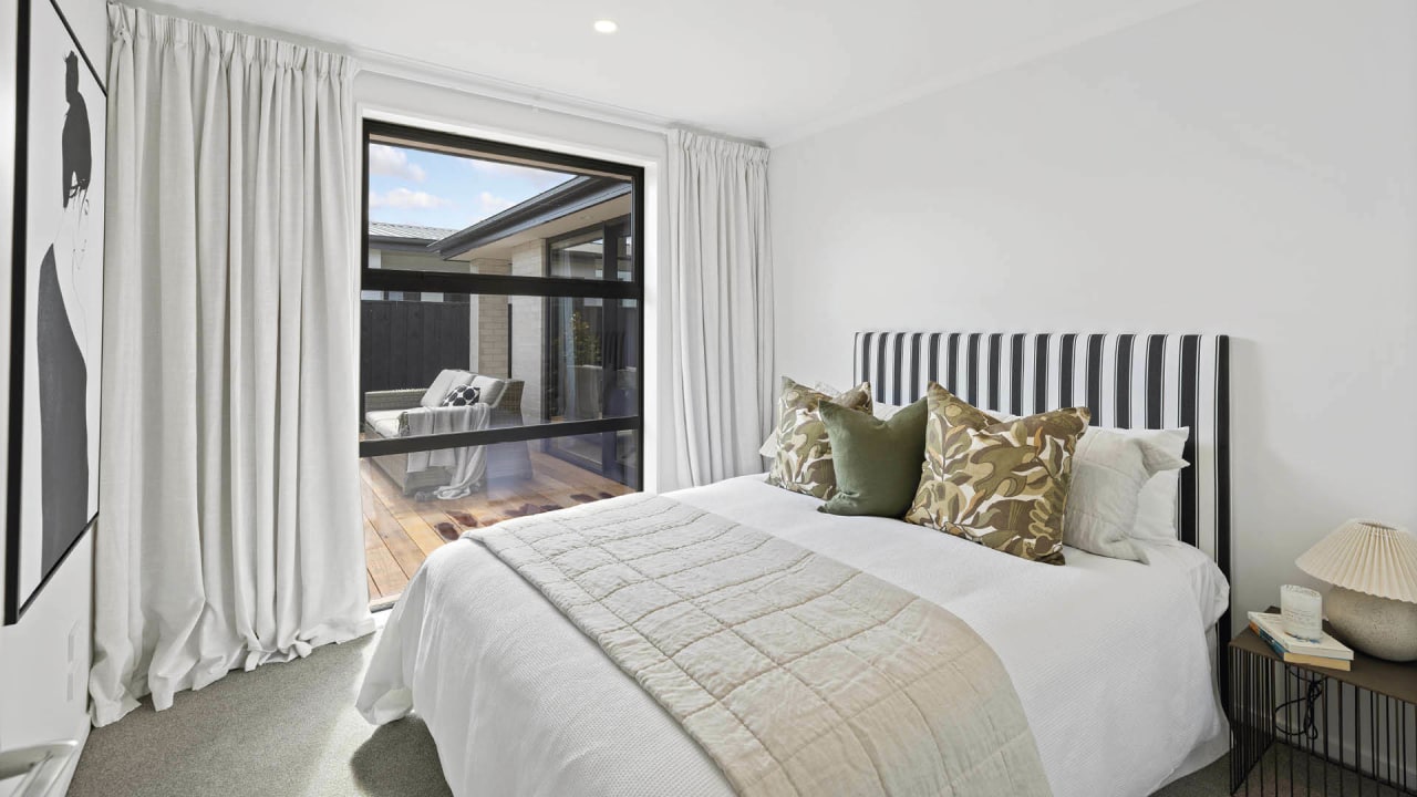 Bedroom looking out to deck and family room 