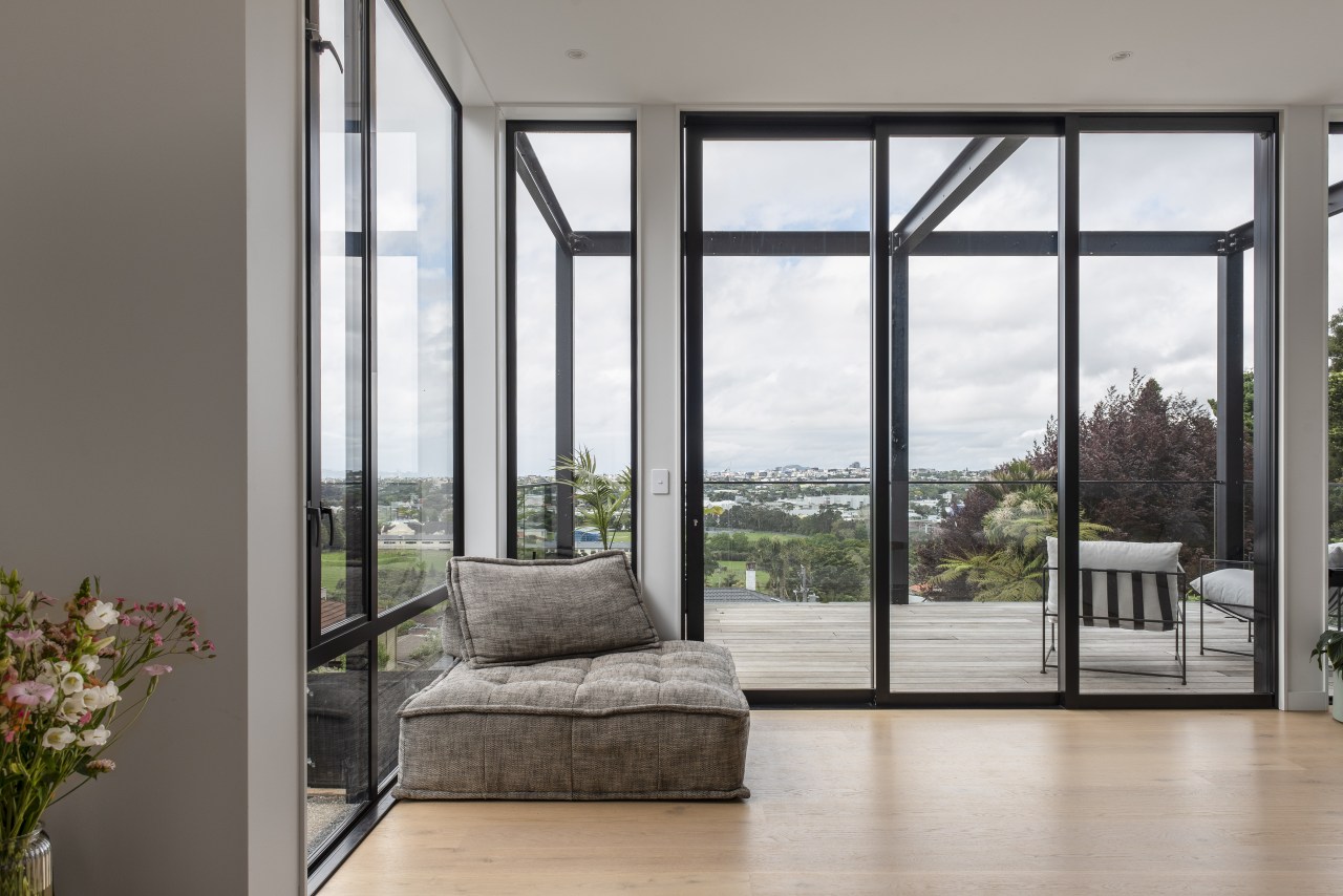 The expansive, sunny living room benefits from floor-to-ceiling 