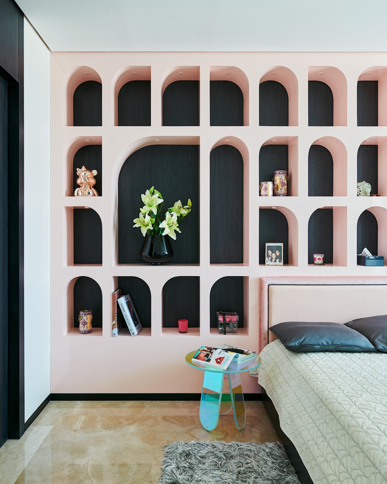 The pink shelving unit behind the bed in 