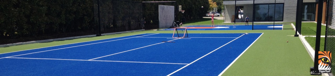TigerTurf multi-sports surfaces are the product of many ball game, floor, grass, individual sports, leisure, net, play, racquet sport, sport venue, sports, tennis, tennis court, tennis player, blue, black