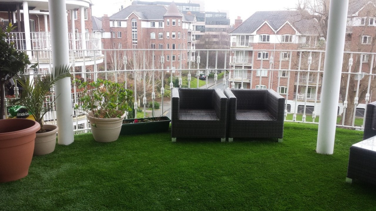 A balcony in Dublin furnished with TigerTurf artificial turf, backyard, chair, flooring, furniture, garden, grass, lawn, outdoor structure, plant, property, shrub, yard, gray, green