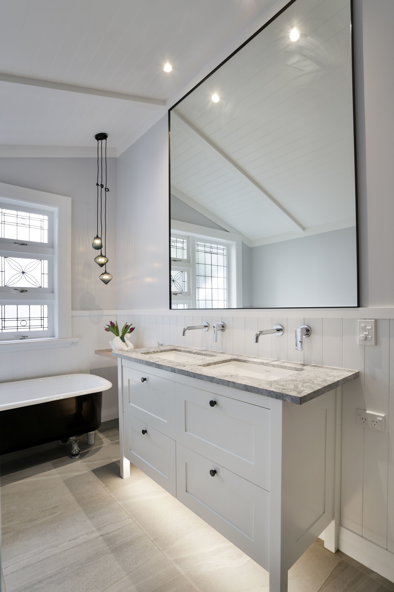 The owner had wanted a traditional look with bathroom, bathroom accessory, bathroom cabinet, cabinetry, countertop, floor, home, interior design, kitchen, room, sink, gray