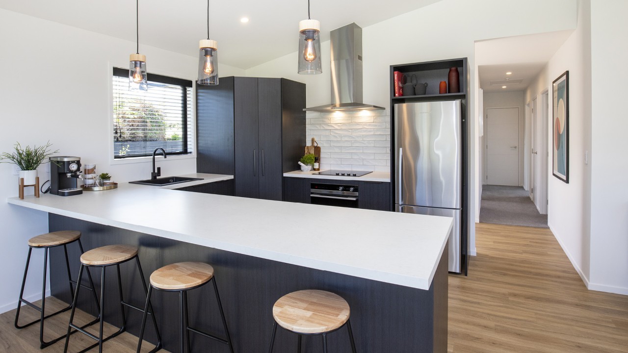 The kitchen includes a breakfast bar, a prep 