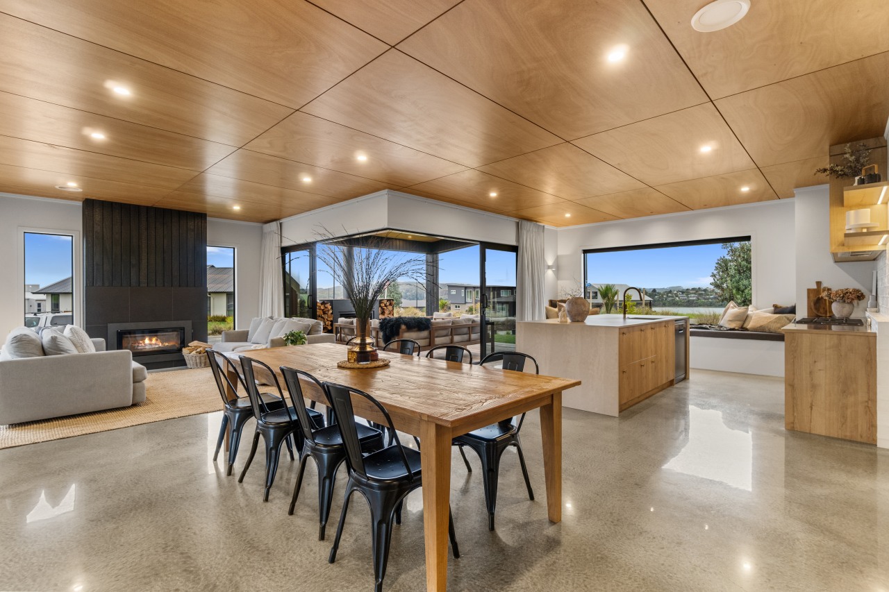 Dining setting in foreground and outdoor living space 